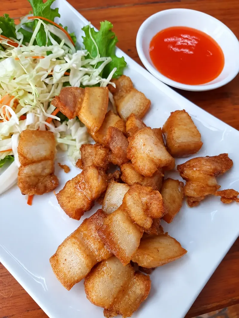 หมูทอดชิ้นพอดีคำพร้อมผักซอยและน้ำจิ้มที่ครัวบ้านวัง